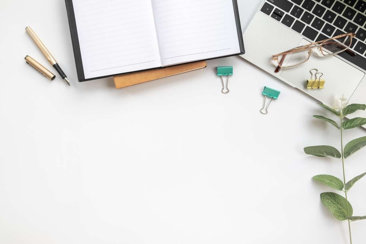 alt=mesa de trabajo con cuaderno